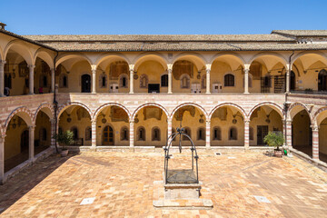 Fototapeta na wymiar Inner courtyard of the Sacro Convento, the friary next to the Basilica of Saint Francis of Assisi, Umbria, Italy