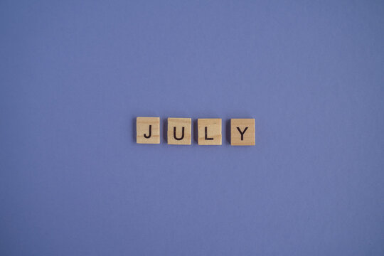 The seventh month of the year July - from isolated letters on wooden blocks in natural color, in high resolution. Very Peri Color of the Year 2022 background, copy space. Flat lay, step by step, step7