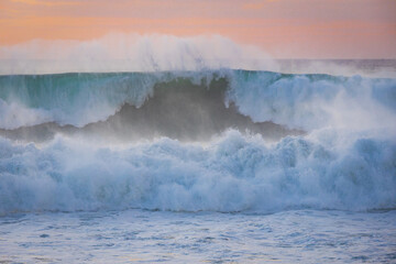 Ocean waves close up at sunset. Guincho beach, Cascais, Portugal