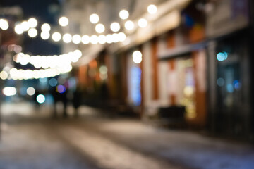 Beautiful garland on the city street in winter, blurred festive background