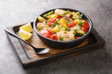 Homemade white sea fish stew with vegetables close-up in a bowl on the table. horizontal