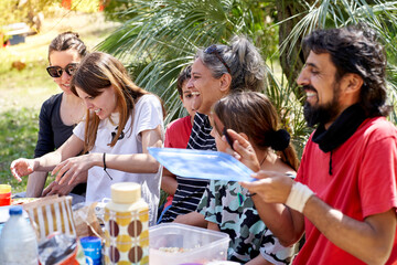 Multiracial family enjoying a picnic in the countryside. Real people