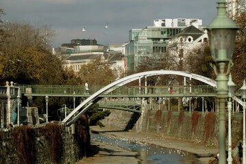 Metal arch bridge in Vienna City Park. Green park area for recreation and walks in the center of Vienna, in the Inner City with an area of 65 thousand square meters. m. 