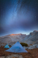 Star trails Milky Way over mountain landscape at night in Inyo Sierra Nevada California