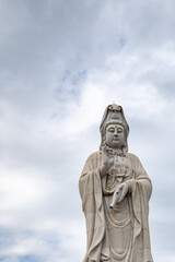 Fototapeta na wymiar Guanyin statue, the Chinese Goddess of Mercy and Compassion, at the Kuang-Im Chapel, a new and unfinished Chinese-style Buddhist temple in Kanchanaburi, Thailand