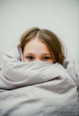 sad girl in autumn in a blanket