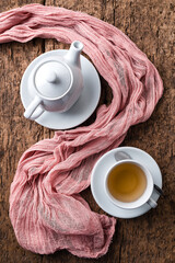 a cup of green tea and a teapot top view