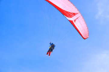 Tandem of two people on a paraglider.