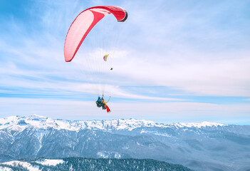 Paragliding flight of two people over the mountains of the Caucasus
