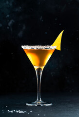 Sidecar cocktail with cognac, liqueur, lemon juice and ice. Black background, copy space
