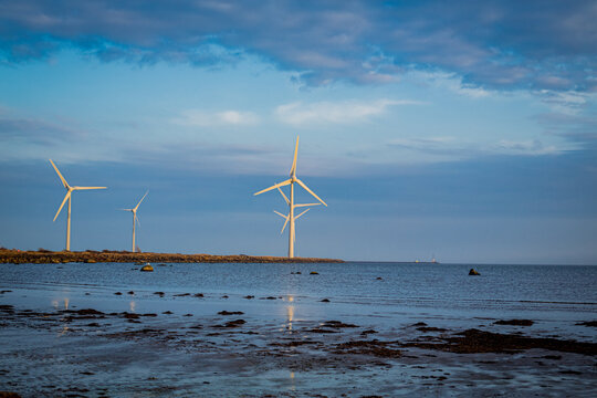 Wind turbines in sunset at Skrea Beach in Falkenberg, Sweden