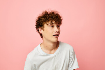 Fototapeta na wymiar portrait of a young curly man posing youth style white t-shirt isolated background unaltered