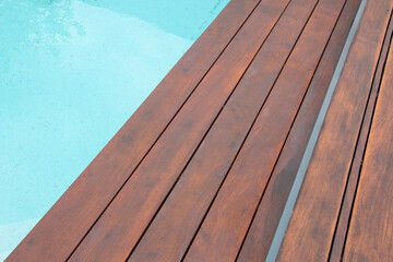 Detail of swimming pool coping and cover constructed by cumaru wood deck, hardwood decking texture...