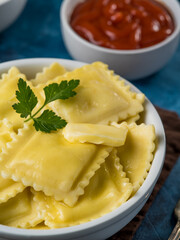 Italian ravioli and tomato sauce. macro photography. Beautifully served table, food design, restaurant, hotel, cafe, home cooking. There is no one in the photo. Advertising, banner.