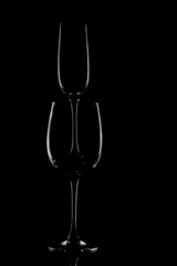 The outline of glass glasses on a black background. Form. Light
