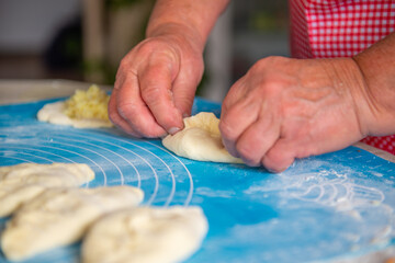 a woman makes a lot of pies out of dough. High quality photo