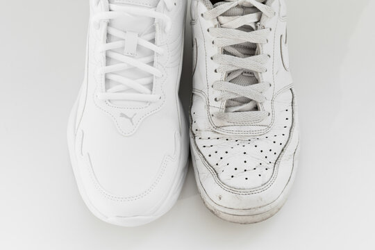 puma and nike. old and new white sneakers with laces on a white background.