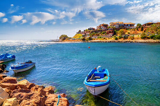Seaside cityscape - view of the pier with boats in the Old Town of Nesebar, on the Black Sea coast of Bulgaria