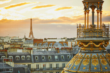 Beautiful Parisian skyline with roofs and dramatic sunset