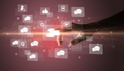 Hand pressing social media multimedia application screen with media icons on futuristic concept