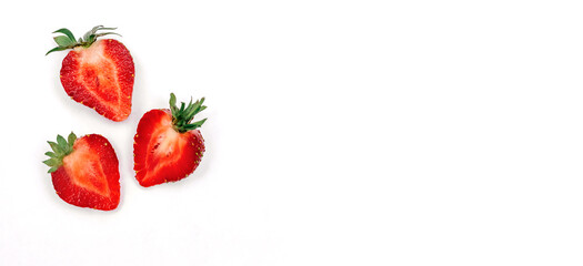Three fresh strawberries in the shape of a heart, cut in half, on a white background.Valentine's Day concept.Creative minimalistic flat lay,copy space, top view.