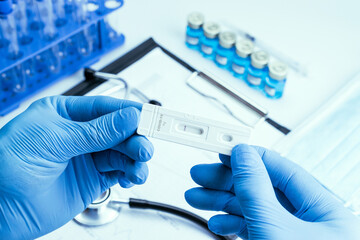Medical test antigen coronavirus kit. Laboratory hospital lab background. Doctor holding rapid...
