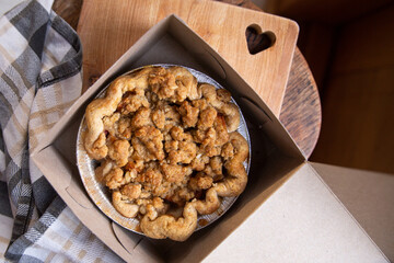 Homemade mini apple crumble pie in bakery box
