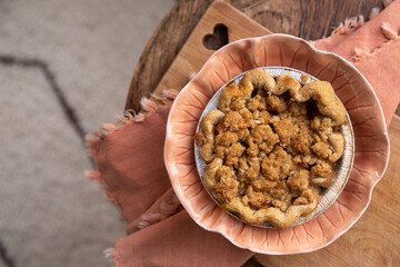 Homemade mini apple crumble pie on pink plate