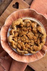 Close up of a homemade mini apple crumble pie on pink plate