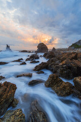 Water flowing between rocks on the coastline.