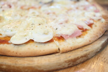 fast food and unhealthy eating concept - close up of pizza   on wooden table