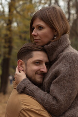 Fototapeta premium hugs of a couple in love outside; vertical frame; close-up image