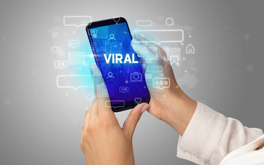 Hand using smartphone with social media concept