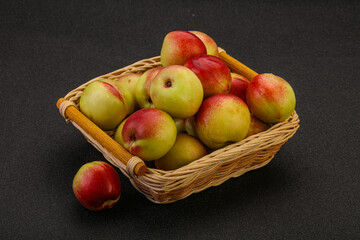 Sweet small nectarines in the basket