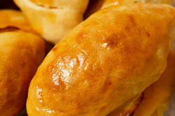 Traditional turkish breakfast savory pastry food close-up top view. It is known as Poaca or Poğaça in Turkish. It is a very popular breakfast food. Cheese, olives, sausage can be put inside.