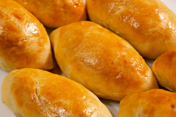 Traditional turkish breakfast savory pastry food close-up top view. It is known as Poaca or Poğaça in Turkish. It is a very popular breakfast food. Cheese, olives, sausage can be put inside.