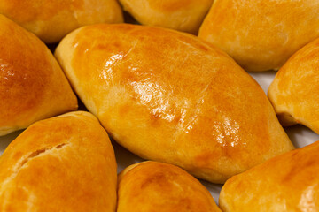 Traditional turkish breakfast savory pastry food close-up top view. It is known as Poaca or Poğaça in Turkish. It is a very popular breakfast food. Cheese, olives, sausage can be put inside.