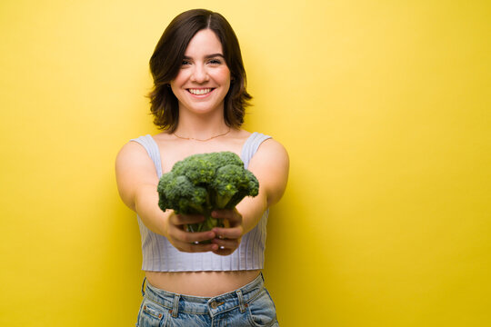 Smiling Woman Loves Eating Broccoli