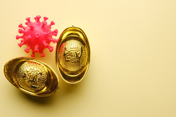 A picture of gold ingot with 3D printed coronavirus on copyspace yellow background for Chinese New...