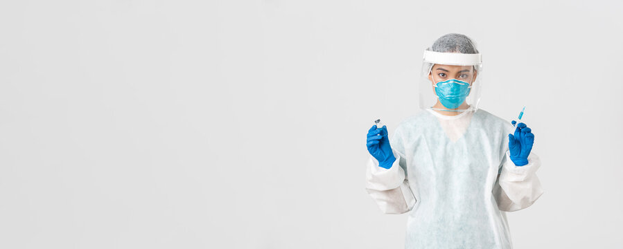 Covid-19, coronavirus disease, healthcare workers concept. Confident asian  female doctor, physician in personal protective equipment and respirator,  ready make ingection, holding syringe with vaccine Stock Photo | Adobe Stock