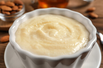 Delicious semolina pudding in bowl on table, closeup view