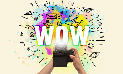 Close-up of a hand holding digital camera with abstract drawing