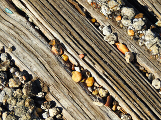 Close Up of Small Rocks Between Wooden Planks