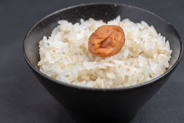A Japanese salted plum on brown rice, Food or culture background, Nobody - obrazy, fototapety, plakaty