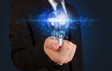 Businessman holding a light bulb