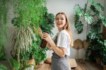 A female florist looks after and works in a workshop of flowers and house plants