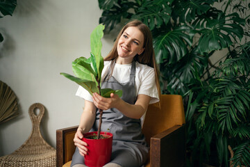 A female florist looks after and works in a workshop of flowers and house plants