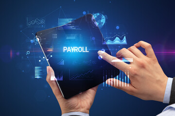 Businessman holding a foldable smartphone, business concept