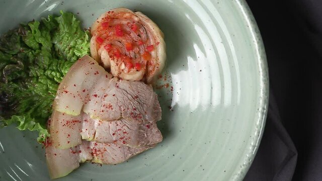 Bossam and kimchi in a ceramic bowl. Pork dishes that are popular with Koreans.
