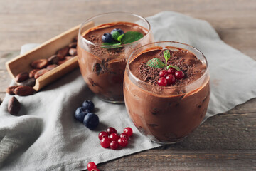 Glasses of sweet cocoa dessert on table